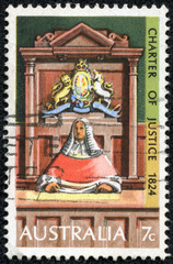 Fototapeta na wymiar stamp printed in Australia shows Supreme Court Judge on Bench