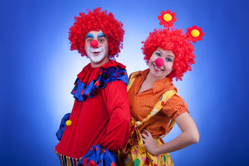 Clowns on blue background studio shooting