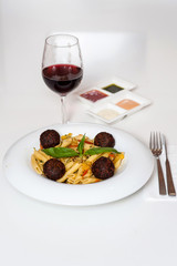 Yummy pasta served with red wine