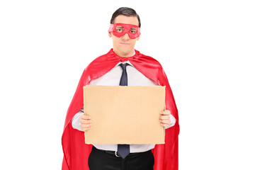 Male superhero holding blank carton sign