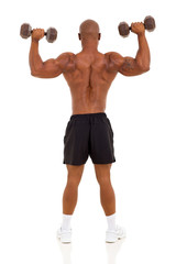 rear view of african bodybuilder training with dumbbells