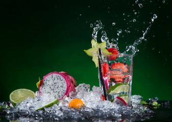 Fototapeta na wymiar Fresh fruit cocktail in freeze motion splashing