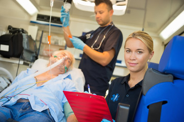Paramedic treating unconscious man in ambulance © CandyBox Images