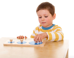 little boy playing at the table