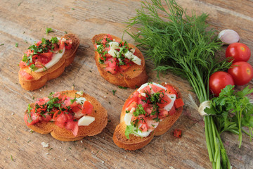 Bruschetta with fresh tomato, garlic, mozzarella and herbs