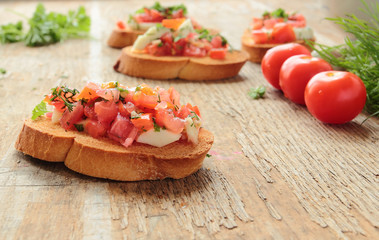 Fresh bruschetta with tomato, mozzarella, garlic and basil