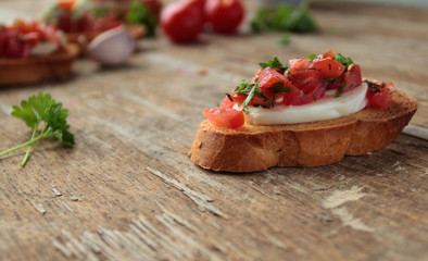 Bruschetta with fresh tomato, garlic, mozzarella and herbs