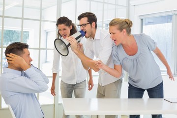 Fototapeta premium Casual business team shouting at a colleague