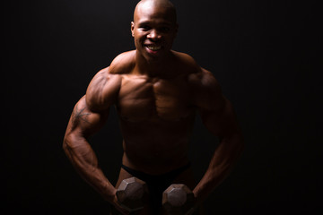 Fototapeta na wymiar muscular man training with dumbbells