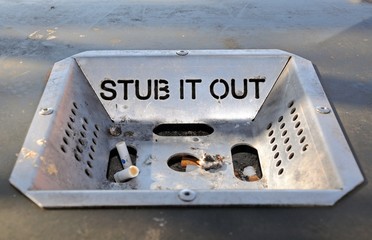 Stub it out ashtray with cigarette ends.