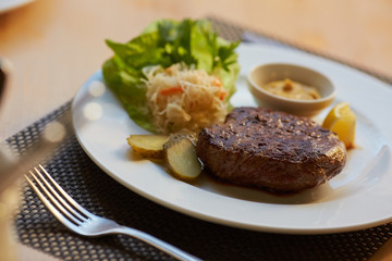 steak with sauce and vegetables