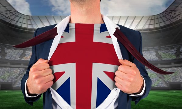 Businessman opening shirt to reveal union jack flag - Powered by Adobe