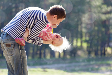 Father holding little laughing child