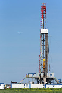 oil drilling rig on green field