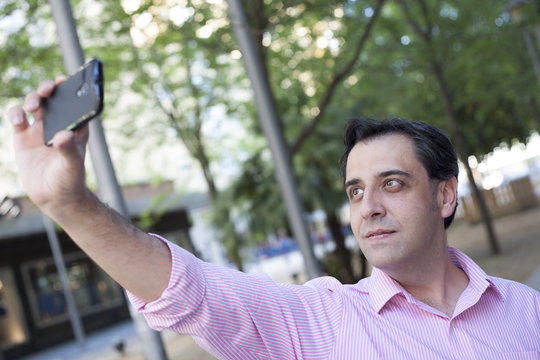 Man taking self portrait with mobile phone