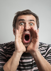 Man shouting with hands cupped around his mouth