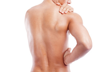 Muscular man holding his back and shoulder in pain, isolated on