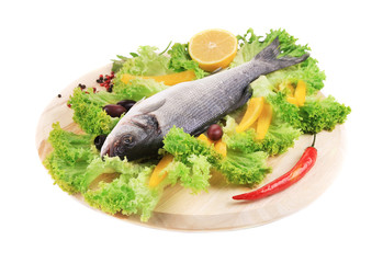 Fresh seabass on platter with lettuce.