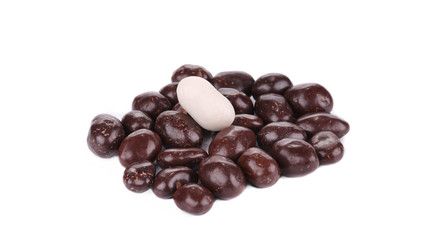 Dark brown dragee in chocolate cover.