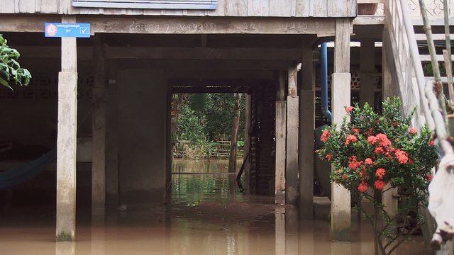Flood waters under stilt-house during the torrential monsoon rains