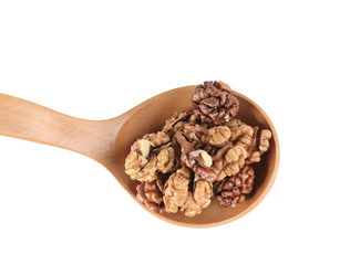 Wooden spoon full with walnuts.