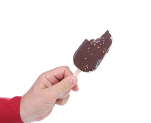 Hand holding chocolate ice cream.