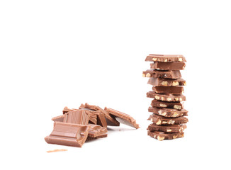 Broken chocolate stack with hazelnuts.