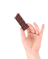 Hand holding tasty dark chocolate bar.