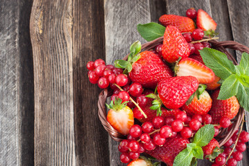 Fresh strawberry and redcurrant in a basket