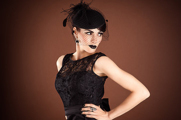 Fototapeta premium Beautiful fashionable woman isolated on retro brown background