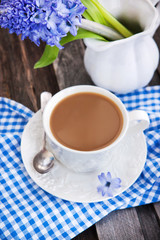Cup of coffee and blue hyacinth