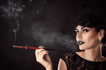 Fototapeta premium attractive woman with dark makeup with mouthpiece