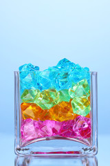 A glass with colorful decorative stones