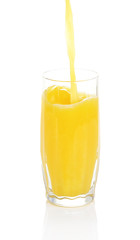 Juice pouring into glass isolated on white