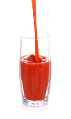 Juice pouring into glass isolated on white