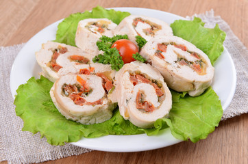 Delicious chicken roll on plate on table close-up