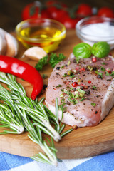 Raw meat steak with herbs and spices