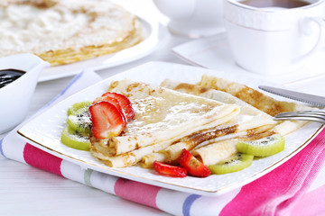 Delicious pancakes with strawberries and chocolate