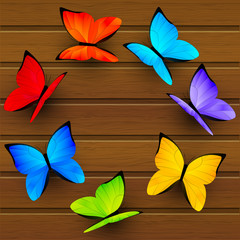 Obraz premium Rainbow butterflies on wooden background