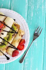 Delicious pancakes with strawberries and chocolate