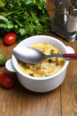 Tasty soup in saucepan on wooden table, close up