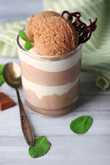 Tasty chocolate mousse with sorbet on wooden table
