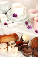 Different tableware on shelf, close up