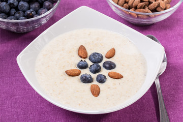 Bowl of oatmeal porridge with walnuts  and blueberry