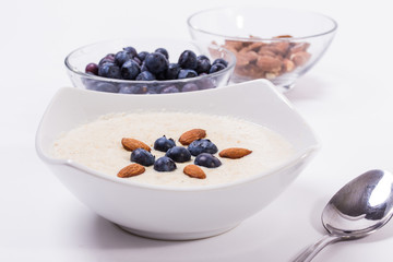 Bowl of oatmeal porridge with walnuts  and blueberry