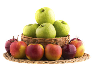 Green and red apples in a wicker baskets.