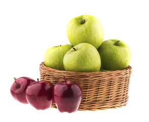 Green and red apples in a wicker baskets.