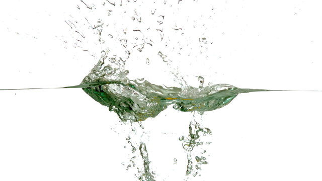 Lemon plunging into water on white background