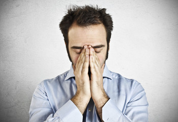 Stressed businessman with hand on the head