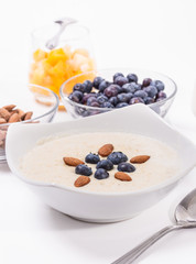 Bowl of oatmeal porridge with walnuts  and blueberry